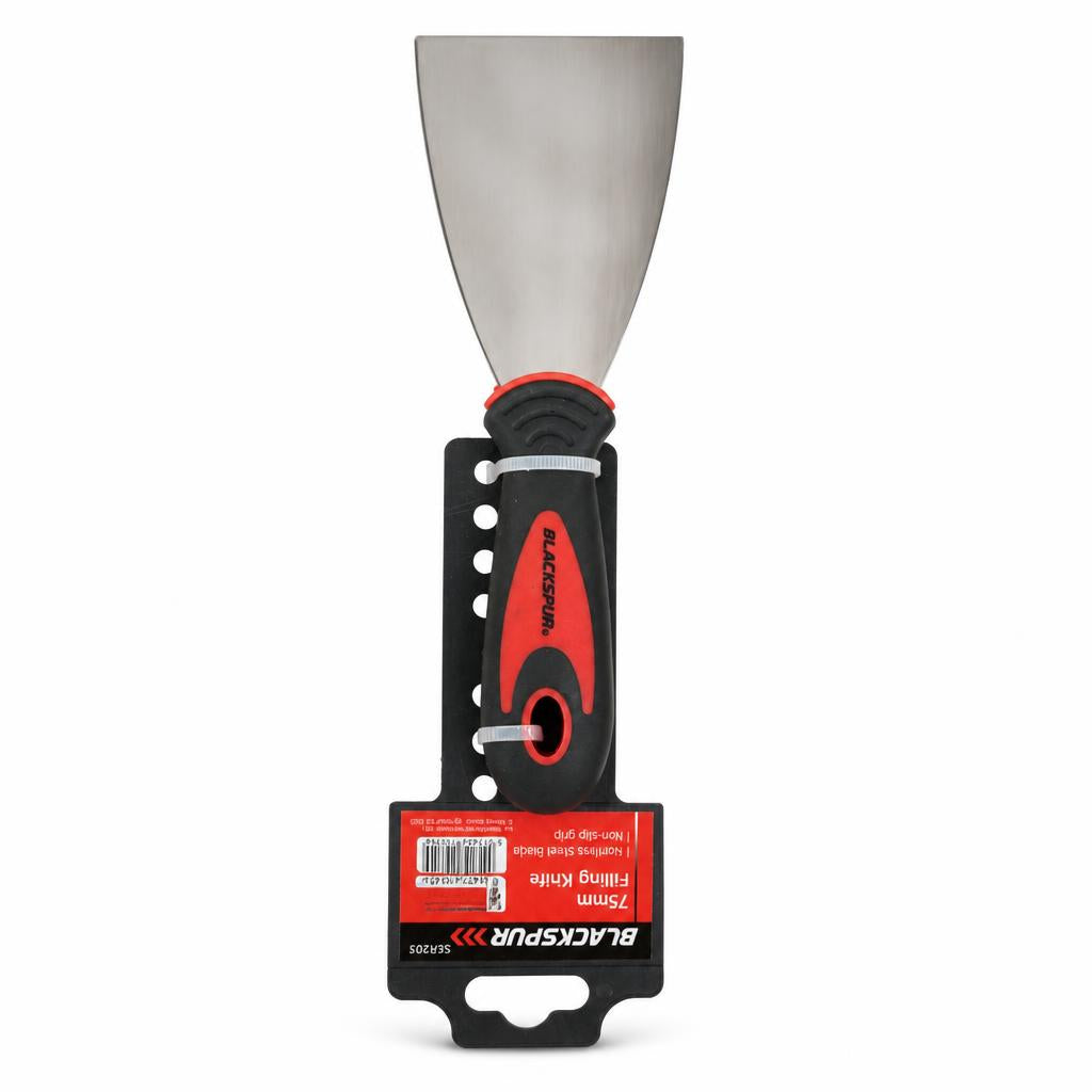 Stainless steel filling knife on wooden surface